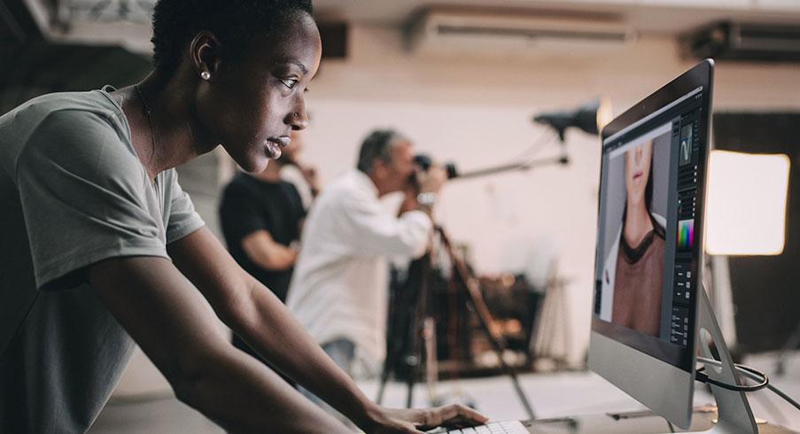 A woman creating a design in Photoshop